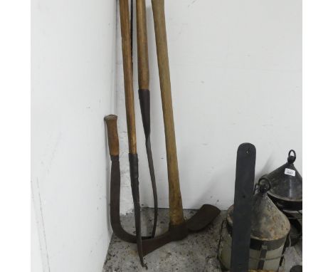 Four various vintage tools including a sickle by Swift.