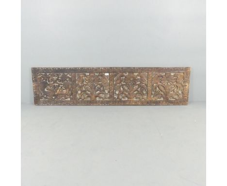 A hardwood wall panel with relief carved decoration. 183x45cm.