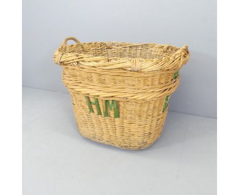 A vintage wicker basket, marked HM. 87x70x70cm.