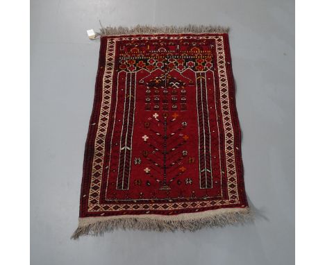 A small red-ground Persian prayer rug. 100x75cm. Good overall condition, some light wear.