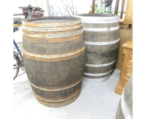 A matched pair of vintage coopered oak barrels. 75x100cm. WITH THE OPTION TO PURCHASE THE FOLLOWING LOT.