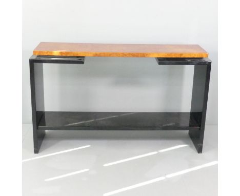 A contemporary burr walnut veneered two-tier console table on black lacquered frame. 129x80x35cm.