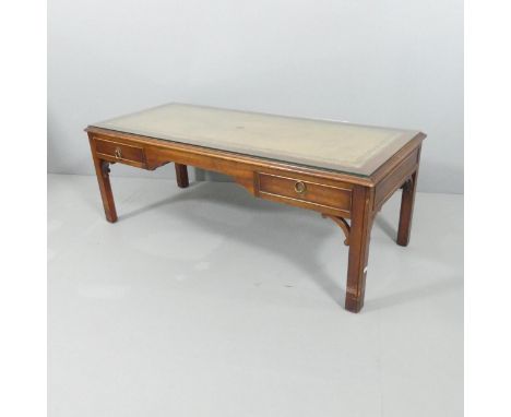 A campaign style mahogany and brass mounted campaign style coffee table, with tooled and embossed leather panel and two friez