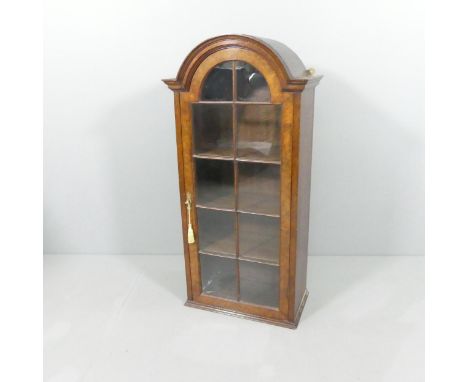 An antique mahogany and walnut veneered arch-top cabinet, with single lattice glazed door and shelf fitted interior. 51x105x2