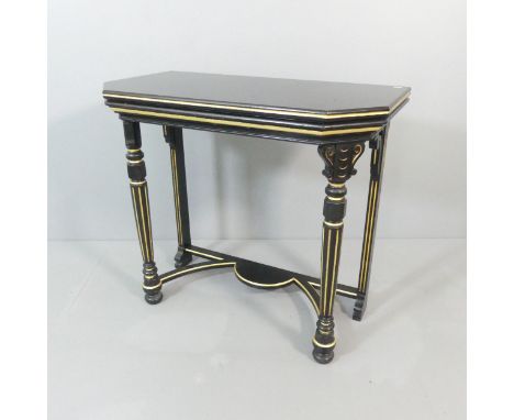 A contemporary ebonised and gilt-painted two-tier console table of canted form with fluted decoration. 92x82x48cm.