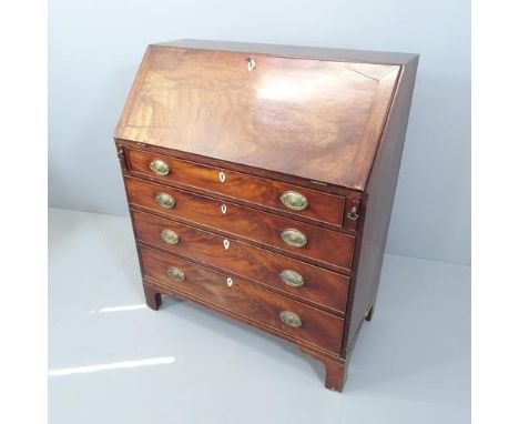 A Georgian mahogany bureau, the fall front revealing a fitted interior with four long drawers below, with brass handles, ivor