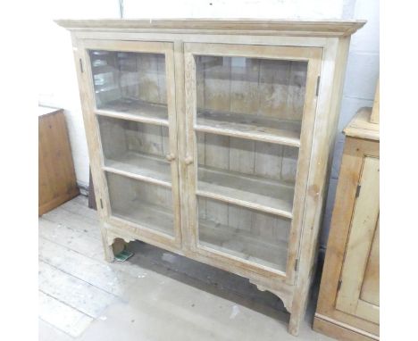 An antique pine dresser top, with two glazed panelled doors and shelf fitted interior. 132x139x36cm.