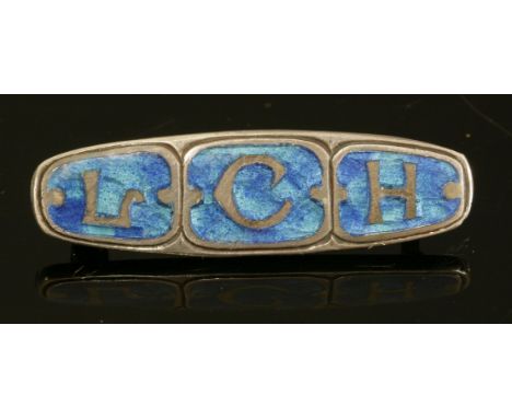 A sterling silver Arts and Crafts enamel brooch,by William Hair Haseler, with three initials 'LCH' in blue and green enamelle