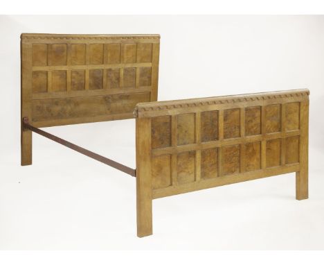 A Robert 'Mouseman' Thompson oak bed,the head and foot boards panelled, with an arcaded top rail, the mouse signature to the 