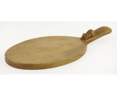 An oak breadboard,by Robert 'Mouseman' Thompson, of oval form, the handle carved with a signature mouse,37cm wide