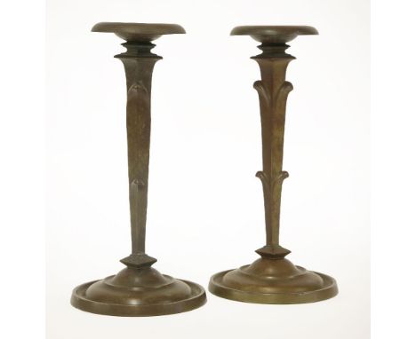 A pair of Art Deco patinated bronze table lamps,possibly by Pertzl, with shaped supports, with dished shaped drip pans, with 