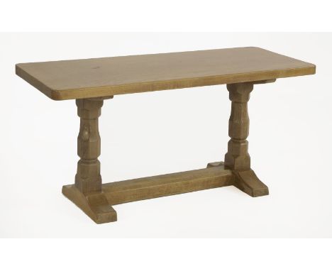 A Robert 'Mouseman' Thompson coffee table,the rectangular top over octagonal carved column supports, on chamfered feet and un