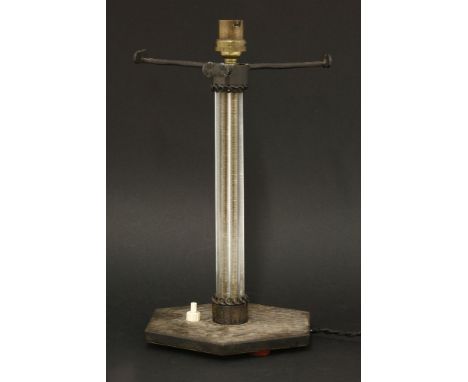 A French Art Deco table lamp,the reeded glass column on a planished hexagonal metal base,30cm high