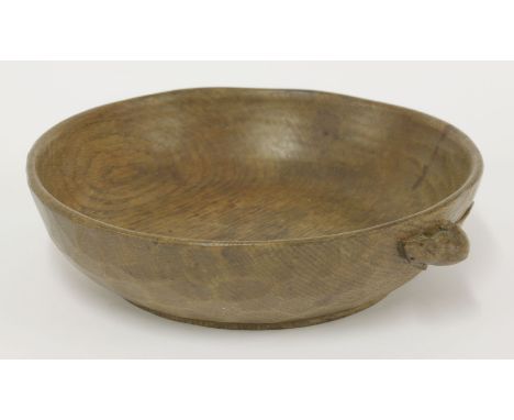 An oak adzed bowl,by Robert 'Mouseman' Thompson, with a mouse signature to the edge,24cm diameter