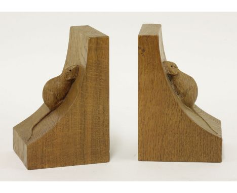 A pair of Robert 'Mouseman' Thompson bookends,of concave form. each carved with the signature mouse, 9cm wide15cm high9.5cm d