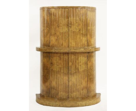 An Art Deco burr walnut cocktail cabinet,attributed to Epstein, in two parts, with fluted cupboards and a central, replaced, 