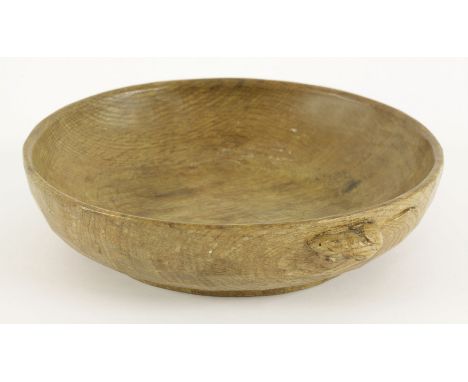 An oak adzed bowl,by Robert 'Mouseman' Thompson, with a mouse signature to the edge,24cm diameter