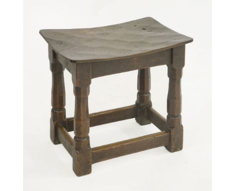 A Robert 'Mouseman' Thompson joined stool,with a dished and adzed top, repaired, on octagonal supports, carved with a mouse s