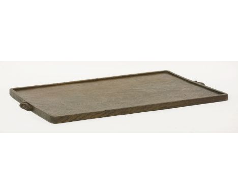 An oak tray,by Robert 'Mouseman' Thompson, with an adzed top, a raised border and signature mice each side,55cm wide33cm deep