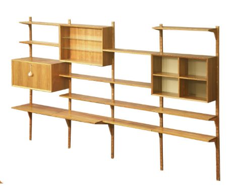 A Danish rosewood wall unit,  §comprising:eleven shelves, 22cm deep,two shelves, 38cm deep,a record cabinet, 38cm deep,an ope