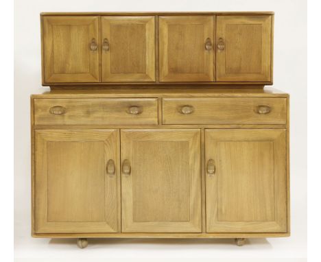 An Ercol sideboard,with two cupboards, enclosing glass shelves over two drawers and three cupboards below, enclosing a shelf 