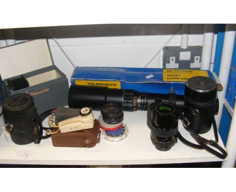 An assortment of vintage photographic equipment, including telephoto lens and Chinon multi-coated lens 