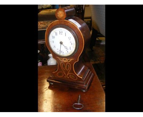 An Edwardian inlaid mantel clock - 27cms highCONDITION REPORTsome minor damage to one side of the clockdoesn't seem to be wor