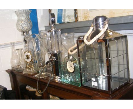 A mantel clock, drink dispenser, glass vases 