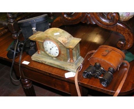 A mantel clock together with two pairs of binoculars