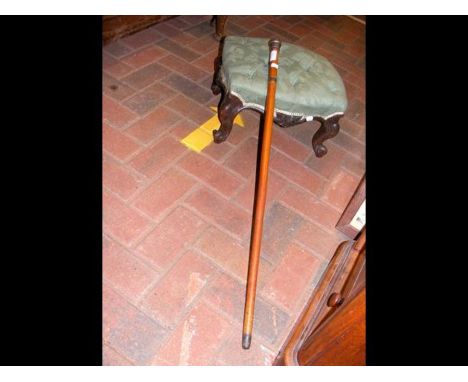 A footstool and walking stick