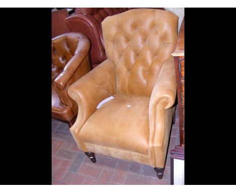 A Victorian style button back easy chair 