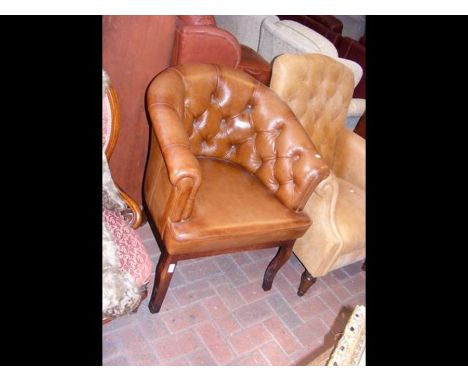 A Victorian style button back tub chair CONDITION REPORTChair is upholstered in brown leather