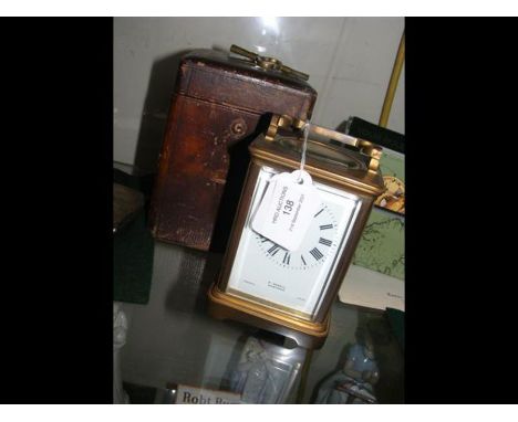 A 19th century brass cased presentation carriage clock in leather carrying case, with key 