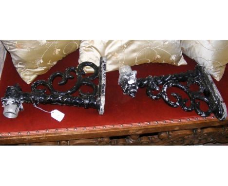 A pair of decorative cast metal outdoor wall light fixtures