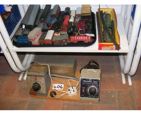 A tray of model trains, including locomotives and rolling stock, together with a power unit on board 