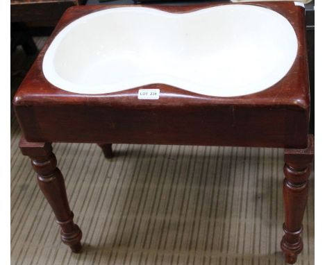 A 19th century mahogany bidet stool with original ceramic liner