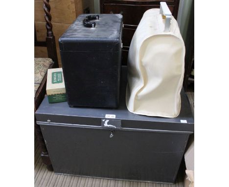 A lockable tin trunk together with two sewing machines