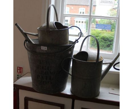 Two vintage galvanized watering cans, together with an egg preserving pail