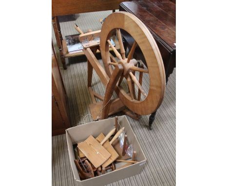 A modern beech manual spinning wheel with accessories