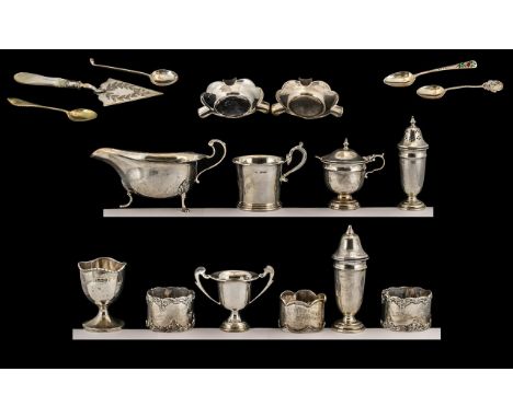 A Collection of Early 20thC Sterling Silver Items. All fully hallmarked. Comprises silver sauce boat, Pepperettes, napkin hol