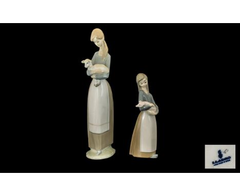 Lladro Handpainted Porcelain Figures (2).  1.  Young woman carrying a lamb.  Height 10.5" - 26.5 cm.   2.  Young girl carryin