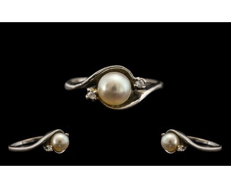Ladies 9ct Pearl &amp; Diamond Set White Gold Dress Ring.  Ring size K.  Twist shape with central pearl with a small diamond 