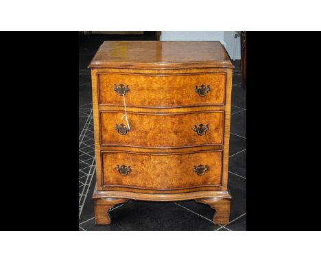 A Reproduction Small Serpentine Fronted Chest of Three Drawers in burr walnut, raised on bracket feet.  Height 27", 21 x 16" 