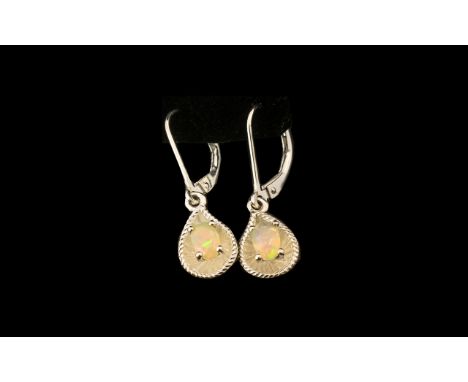 Opal Solitaire Drop Earrings, each oval cut, faceted, opal, mined in Ethiopia, set in a concave pear shaped drop of silver wi