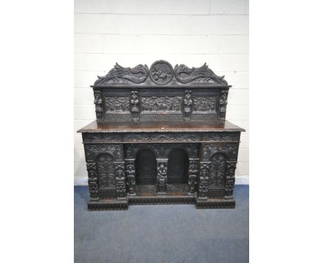 A 19TH CENTURY HEAVILY CARVED OAK SIDEBOARD, the raised back with panelling and shelf, fitted with three frieze drawers, two 