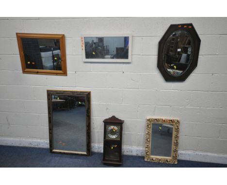 AN OAK OVAL WALL MIRROR, along with four other modern mirrors, a modern wall clock and two lamps (condition report: missing p