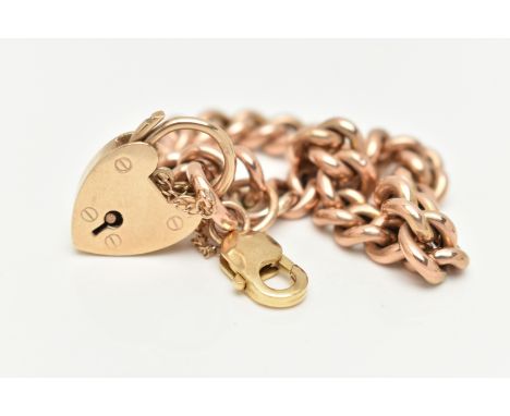 A 9CT GOLD HOLLOW BRACELET, hollow polished curb links, stamp mark to jump ring worn possibly 9ct, fitted with a heart padloc