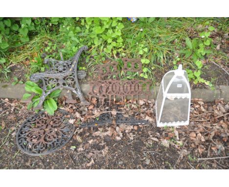 A COLLECTION OF CAST IRON GARDEN ITEMS including seven Victorian lawn edgers, a modern table top, two bench ends, two shelf s