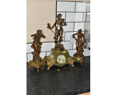 A FRENCH CLOCK GARNITURE 'PAR FERRAND' in green onyx with spelter figures 'Chasse aux Papillons' with hand painted enamel dia