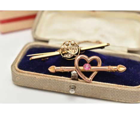 TWO EARLY 20TH CENTURY BROOCHES, the first an open work heart with bar set with a single pink paste stone, unmarked, fitted w